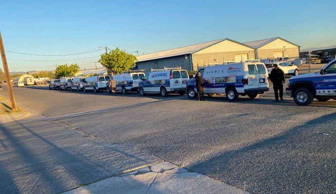 A fleet of Dayspring Restoration emergency service vehicles lined up for dispatch