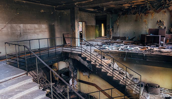 Burnt interior of a fire-damaged building requiring smoke damage assessment