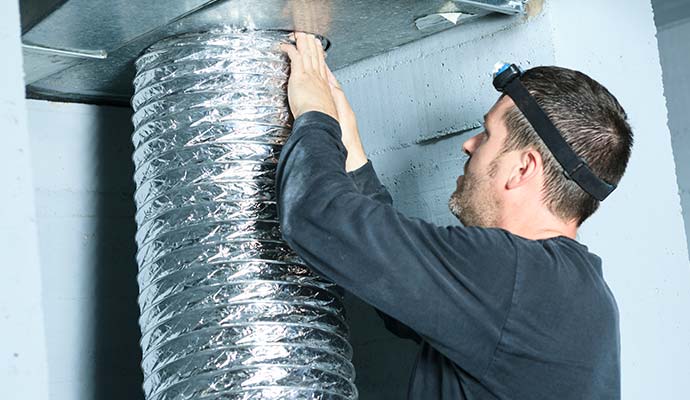 Technician cleaning duct system