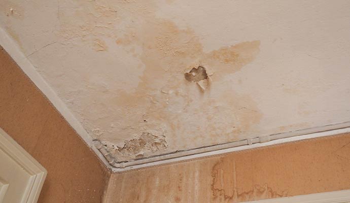 Damaged ceiling due to storm damaged roof