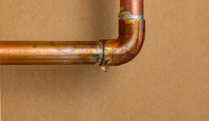 Dropping water from leaky pipe