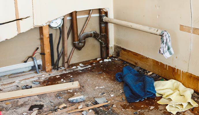 Exposed damaged water line within the structural wall