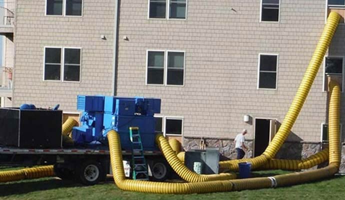 Technician with water damage restoration equipment
